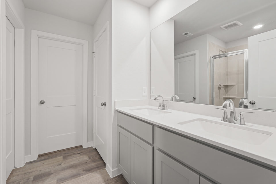 A bathroom with a large mirror.