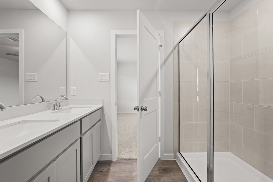 A bathroom with a shower and sink.