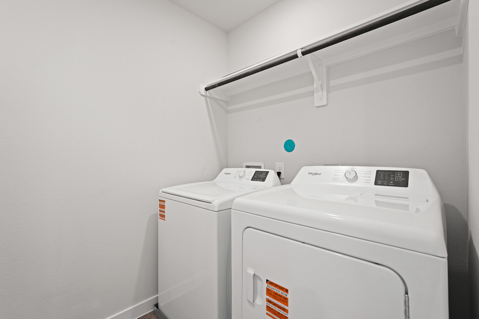 A white machine with a green light.