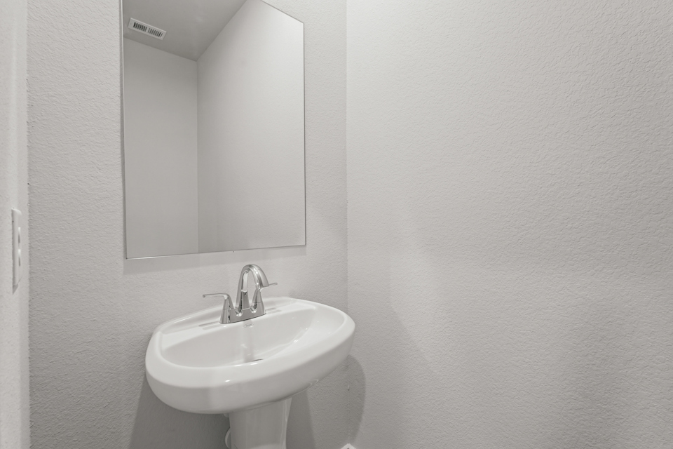 A bathroom with a mirror and sink.