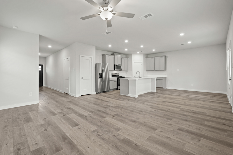 A kitchen with white cabinets.