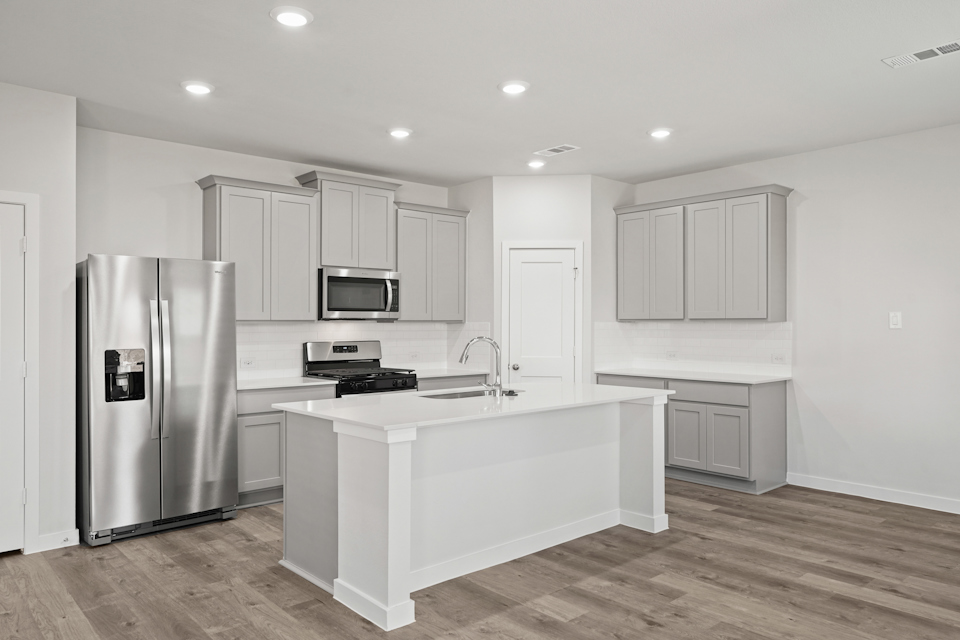 A kitchen with white cabinets.