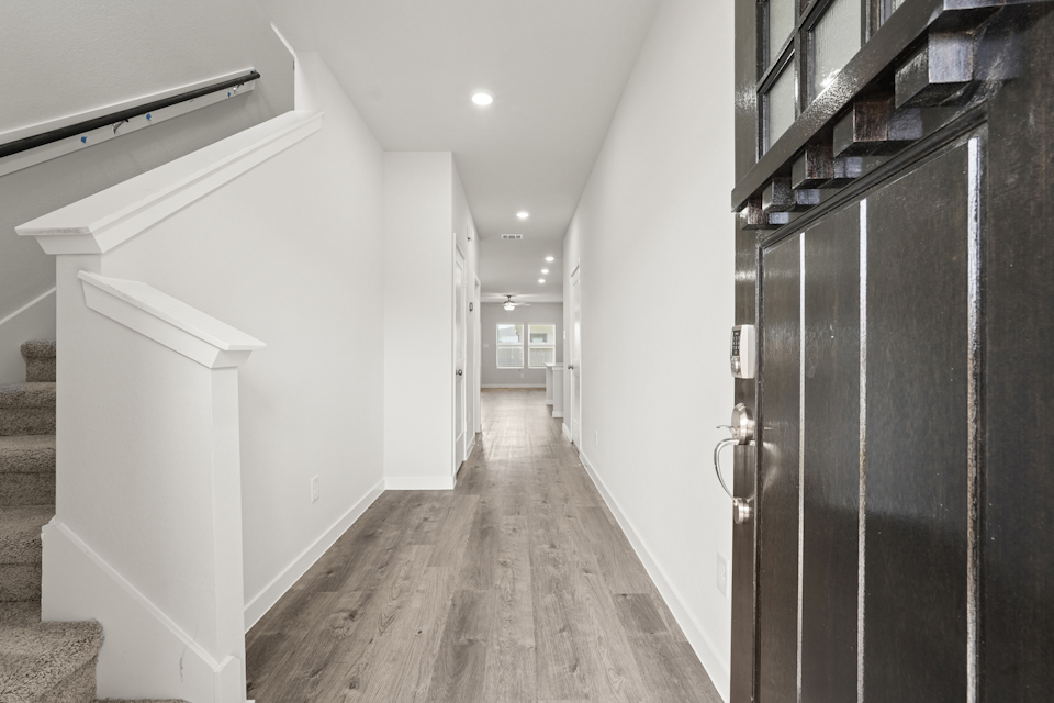 A hallway with white walls.