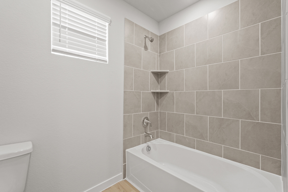 A bathroom with a bathtub and toilet.