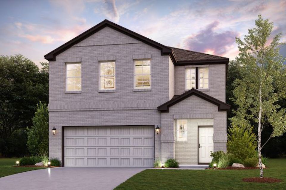 A house with a garage and trees.