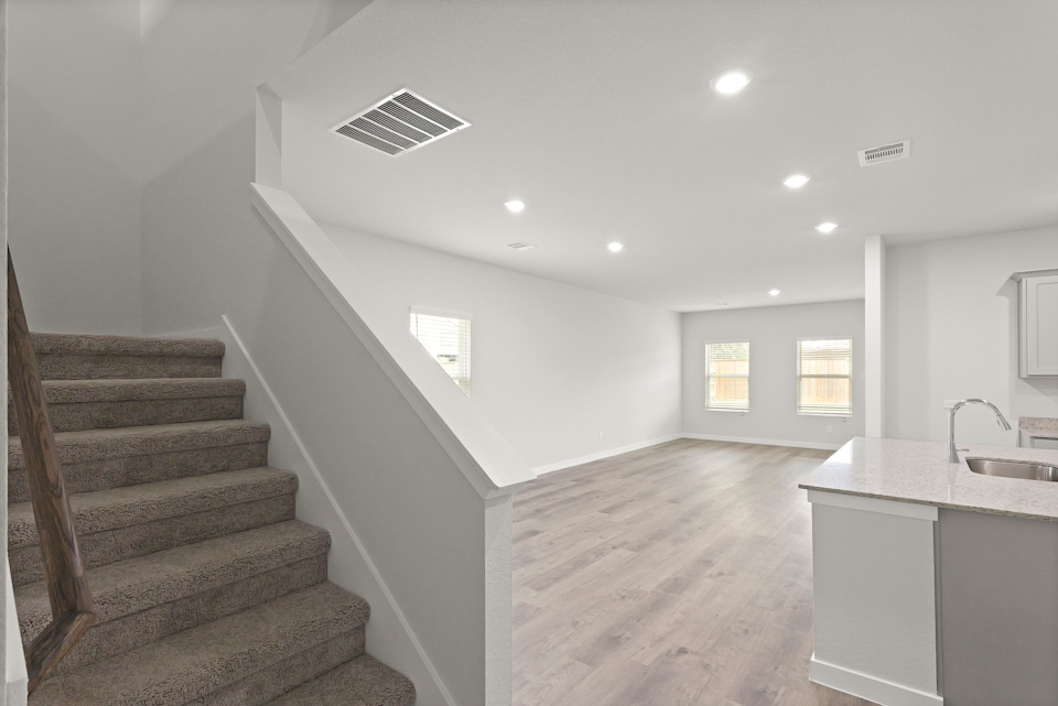 A large bathroom with a staircase.