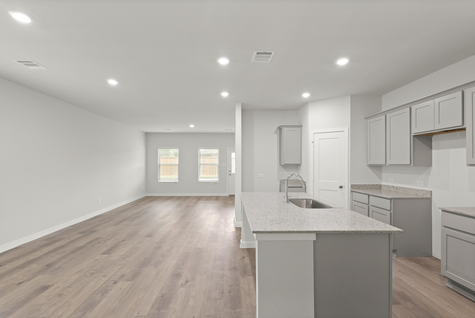 A kitchen with white cabinets.