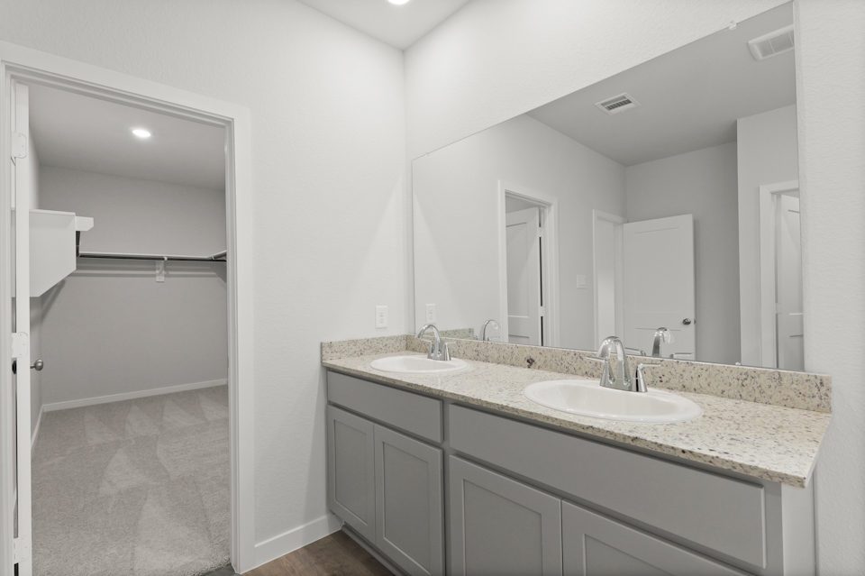 A bathroom with a large mirror.