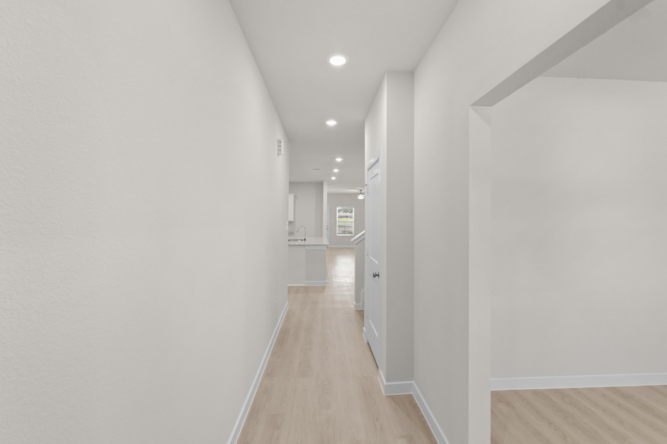 A long hallway with white walls.