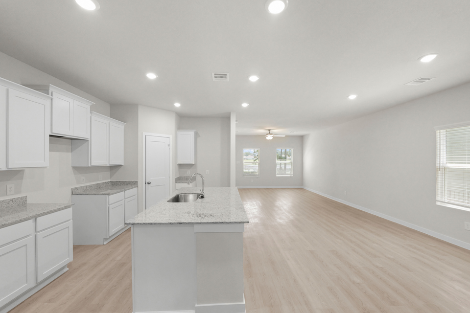 A kitchen with white cabinets.