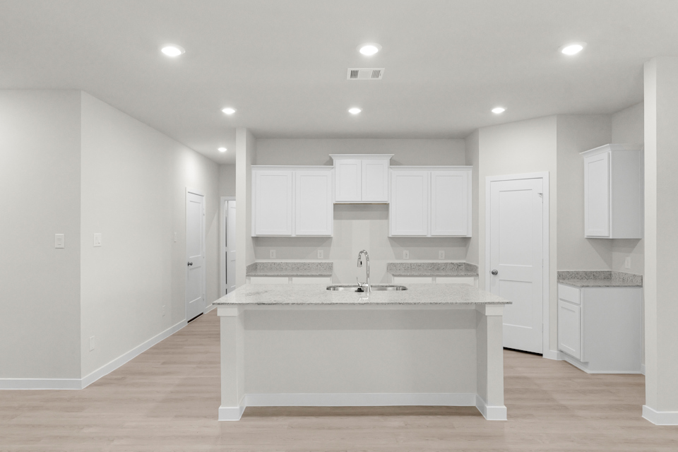 A kitchen with white cabinets.