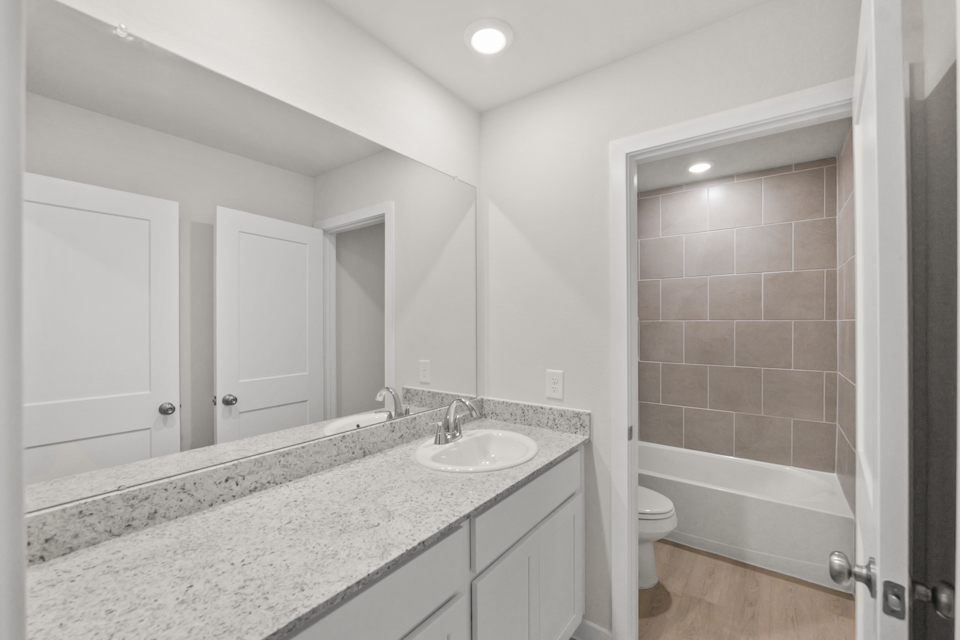 A bathroom with a marble countertop.