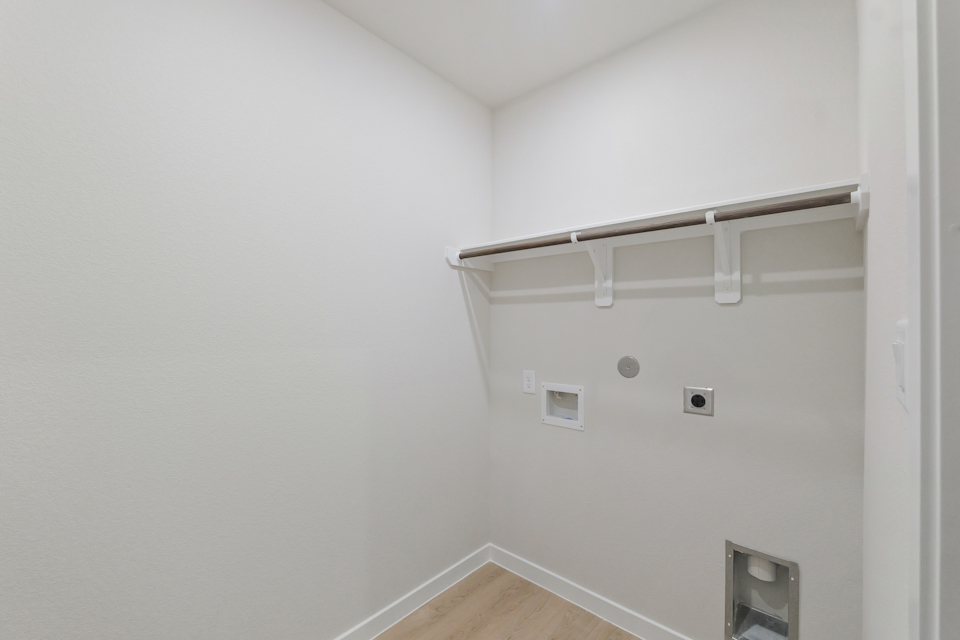 A white wall with a light fixture.