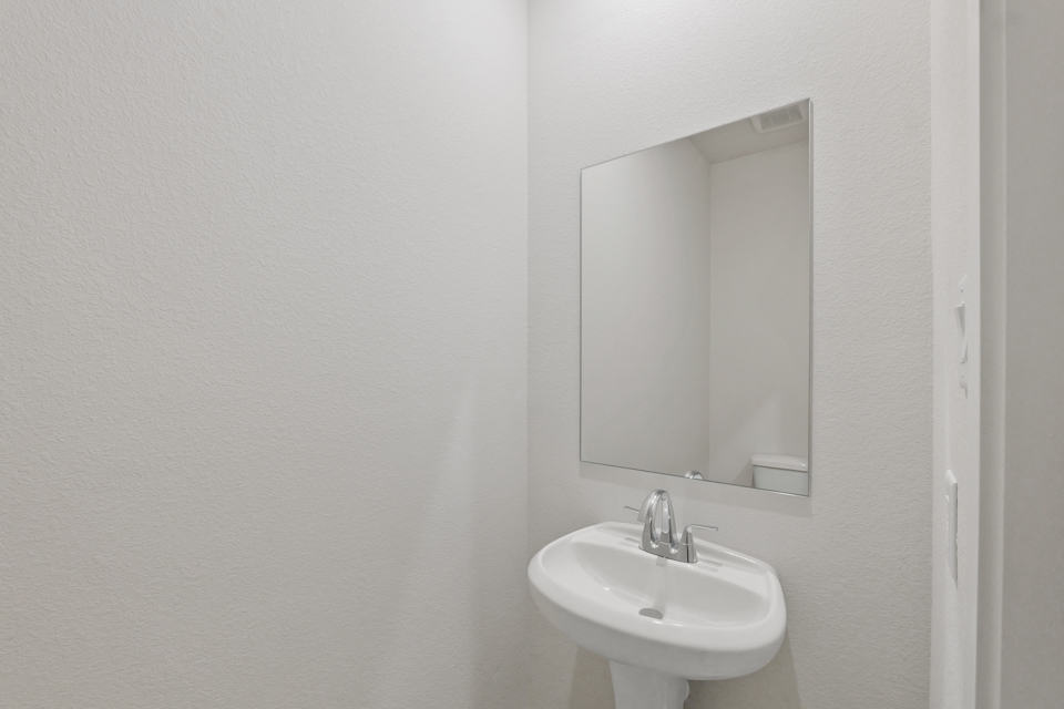 A bathroom with a mirror and sink.