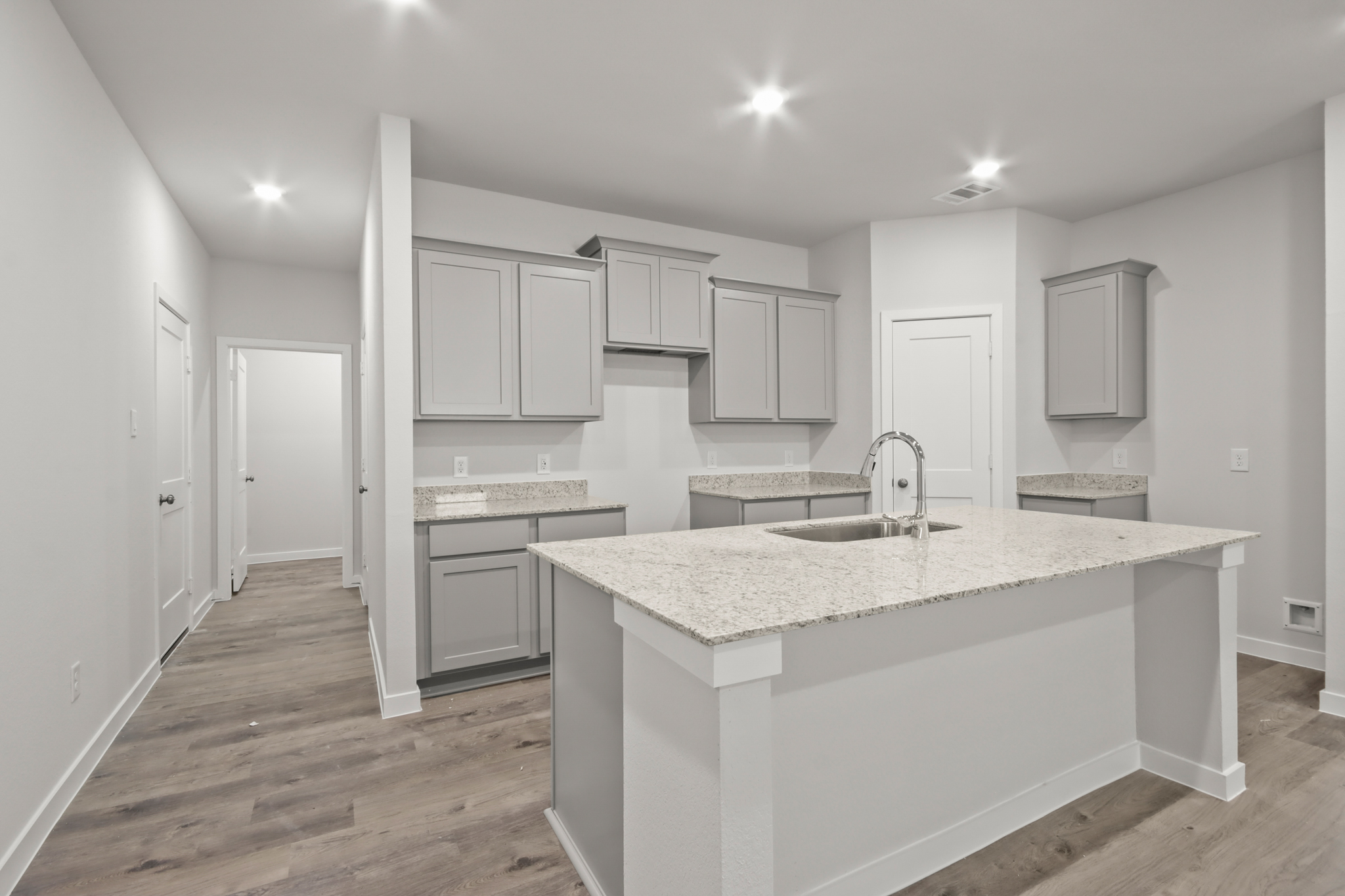 A kitchen with white cabinets.