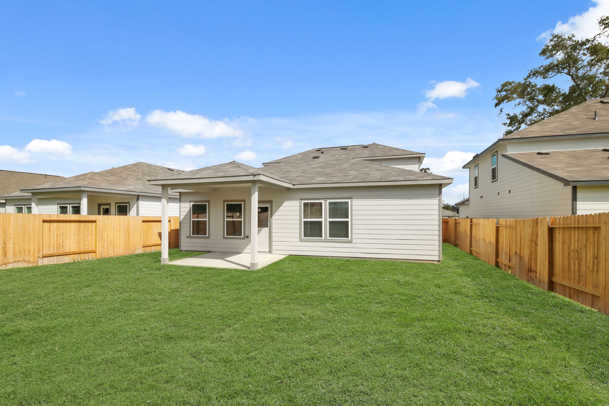 A house with a fence and grass.