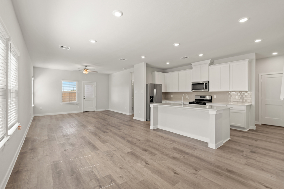 A kitchen with white cabinets.