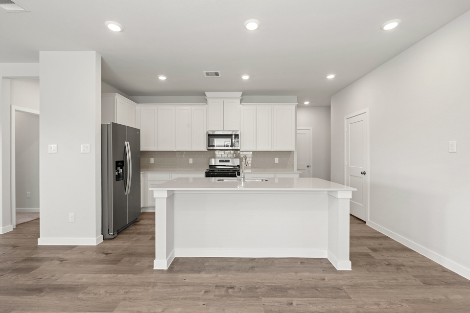 A kitchen with white cabinets.