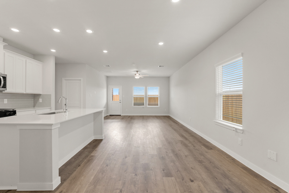 A kitchen with white cabinets.