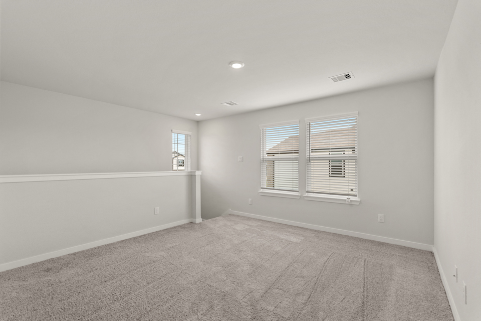 A room with a window and a carpet.