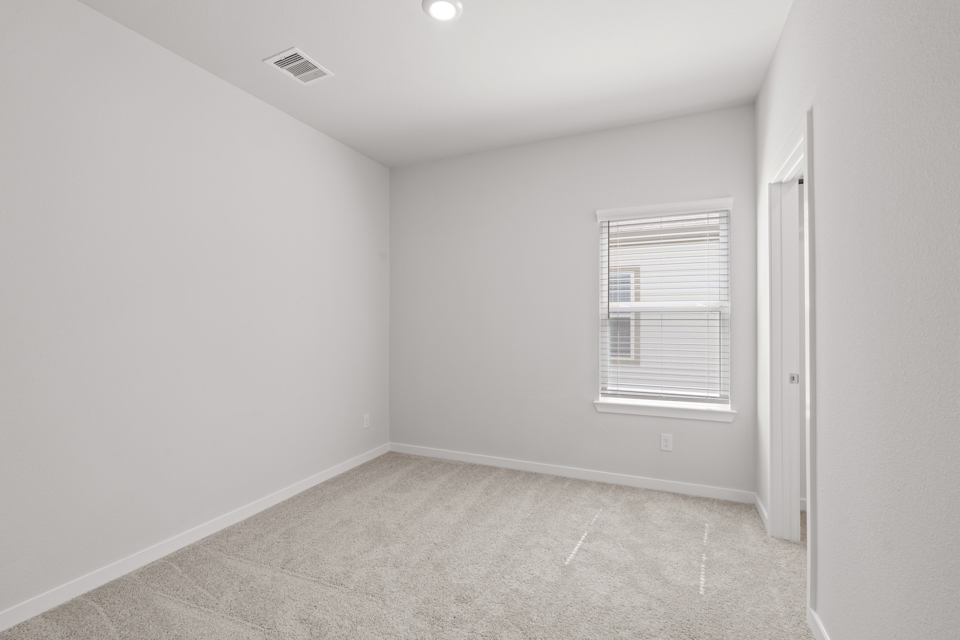 A room with a window and a door.