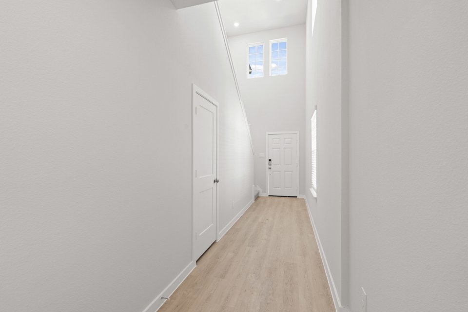 A hallway with white doors.