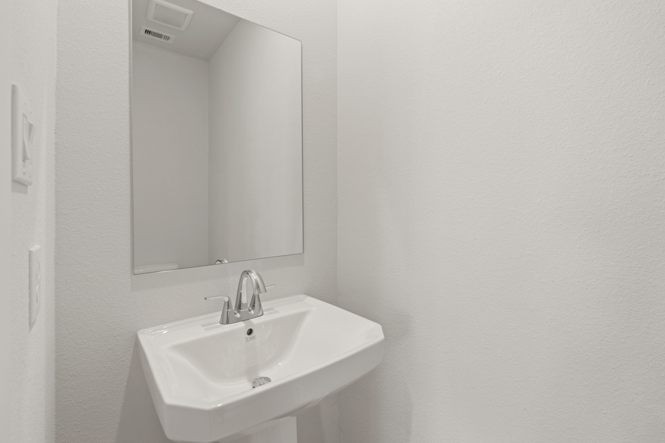 A bathroom with a mirror and sink.