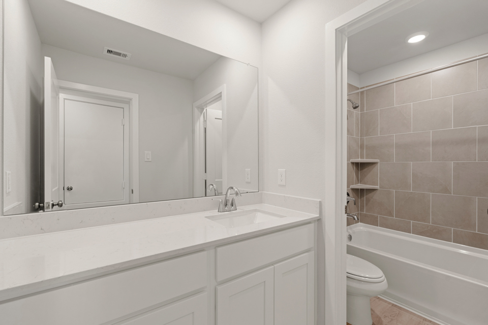 A bathroom with a sink toilet and bathtub.