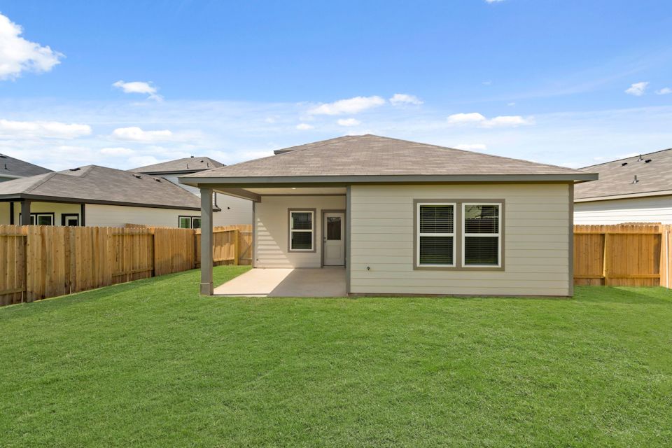 A house with a fence and grass.
