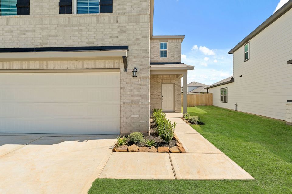 A building with a lawn and a fence.