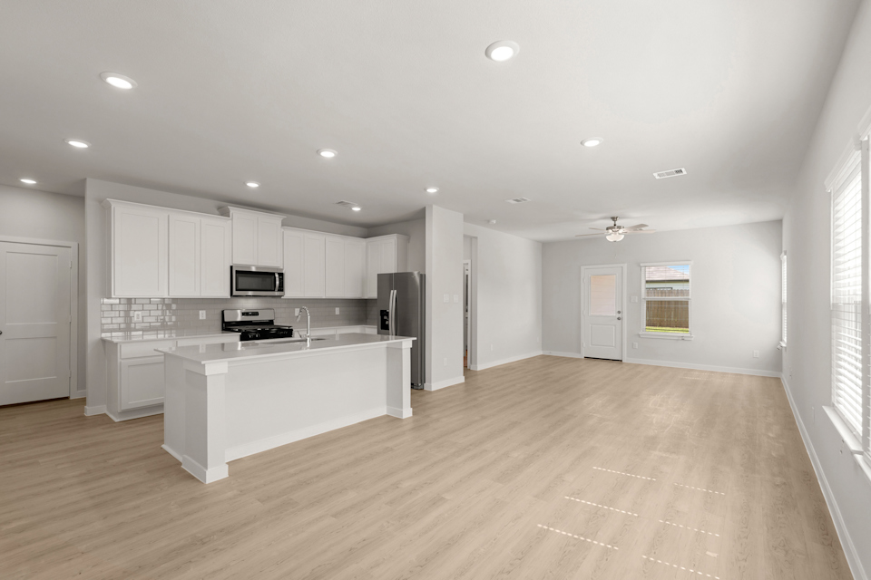 A large kitchen with white cabinets.