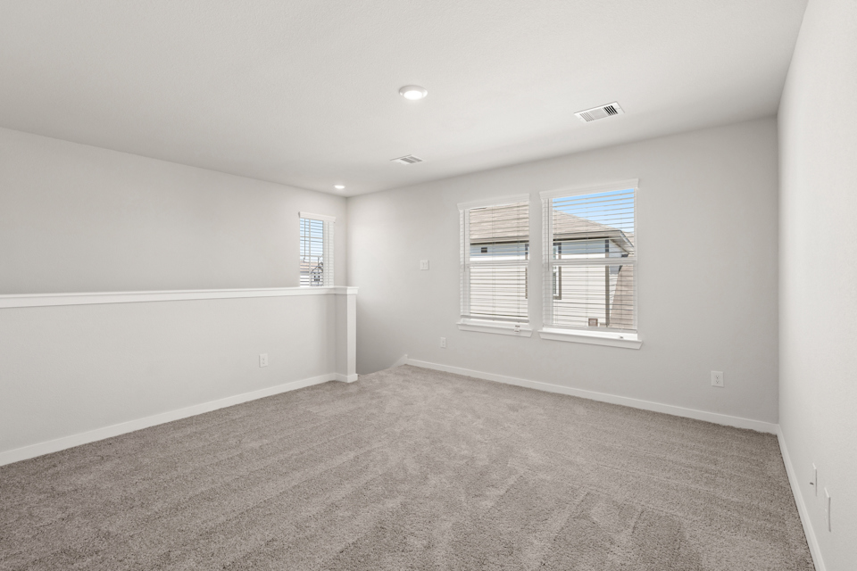 A room with a window and a carpet.