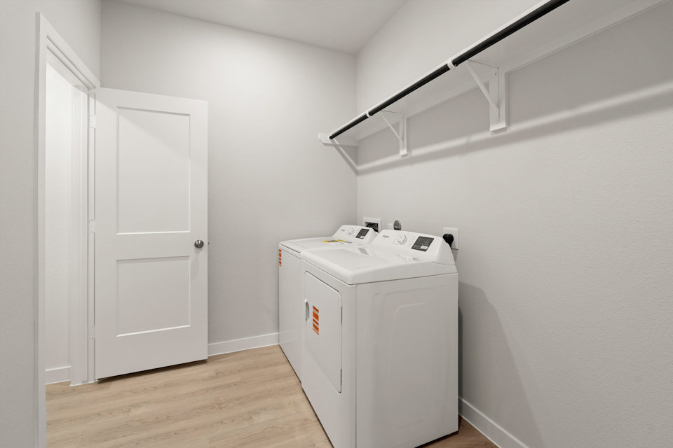 A white room with a white cabinet and a white door.