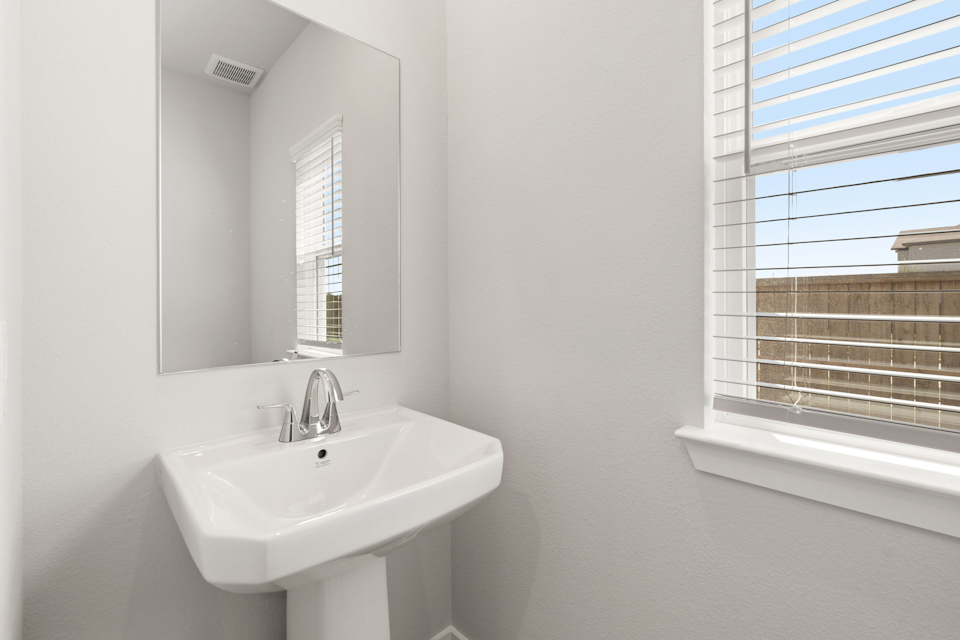 A bathroom with a sink and mirror.