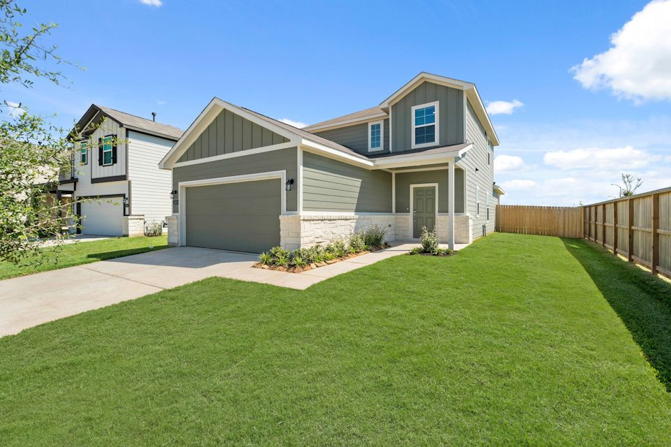 A house with a fence and grass.
