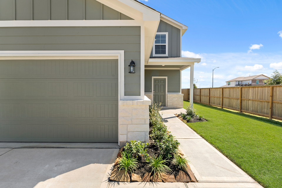 A house with a fence and grass.