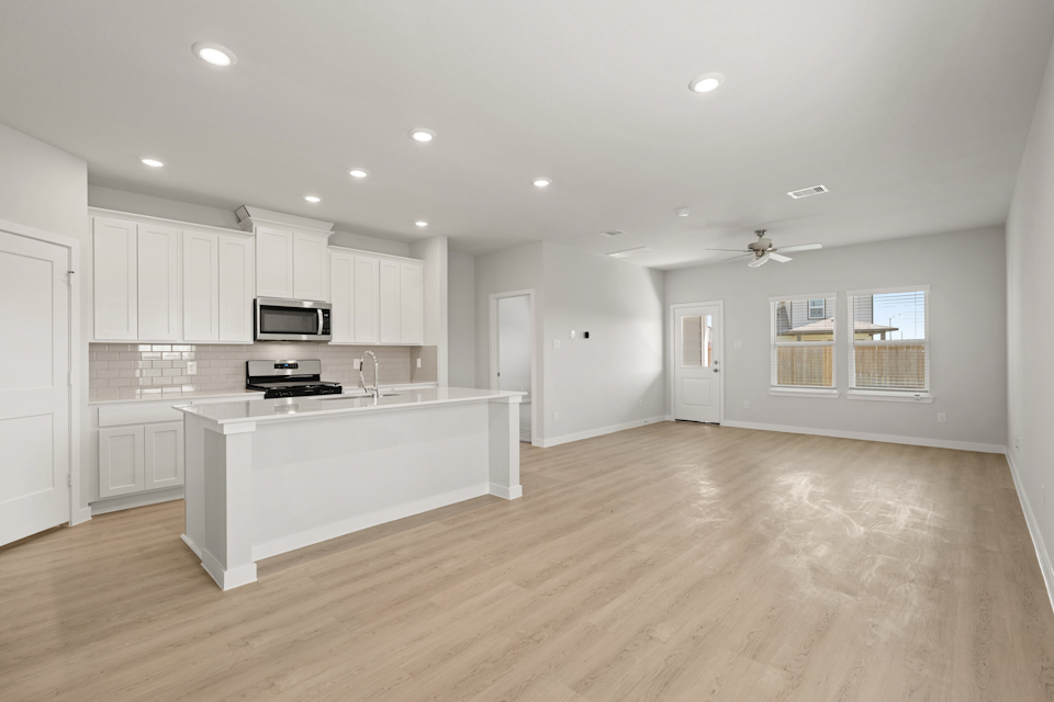A kitchen with white cabinets.