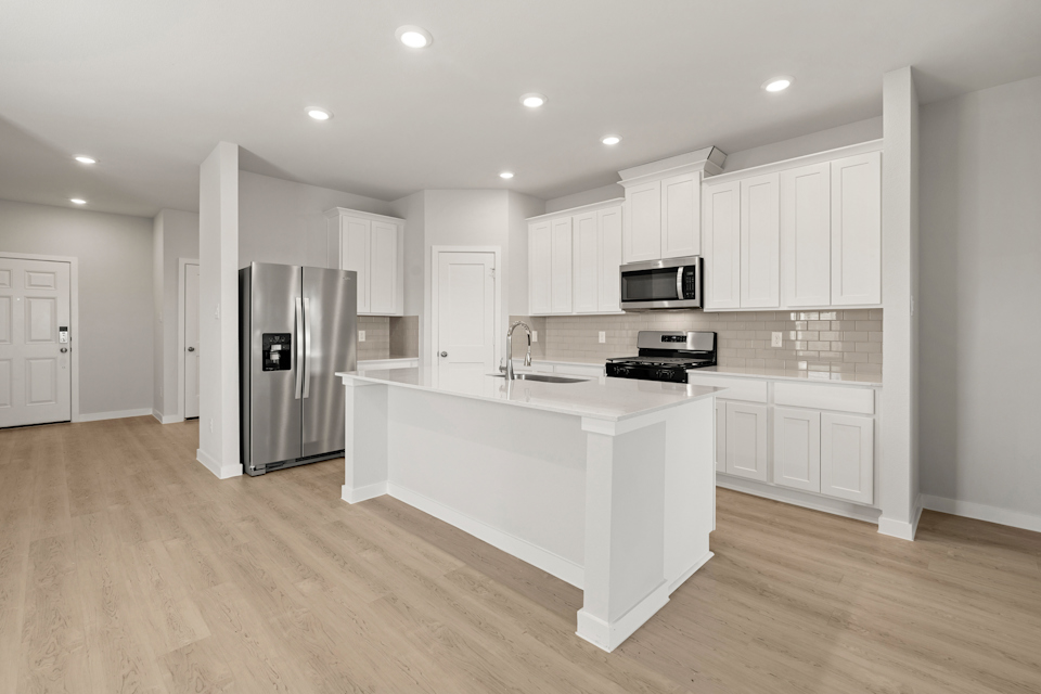 A kitchen with white cabinets.