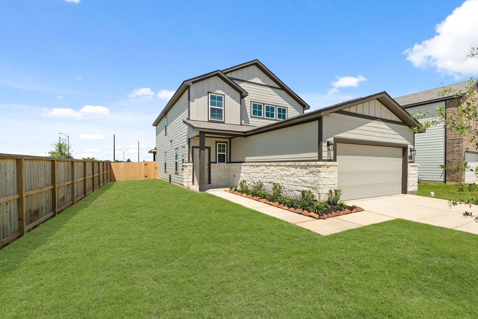 A house with a fence and grass.