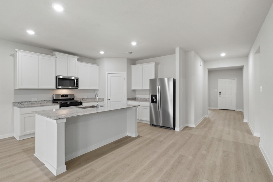 A kitchen with white cabinets.