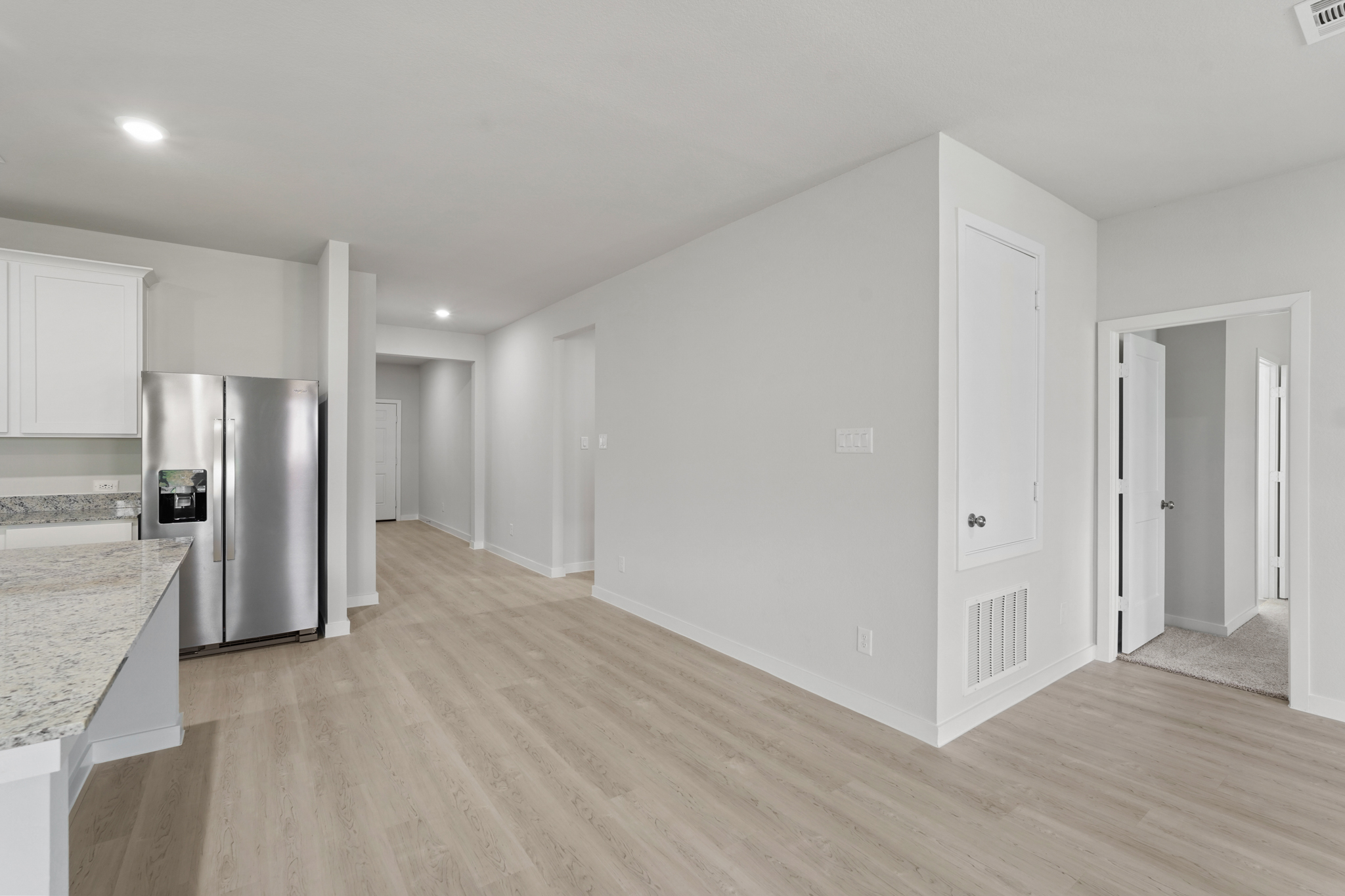 A kitchen with white cabinets.