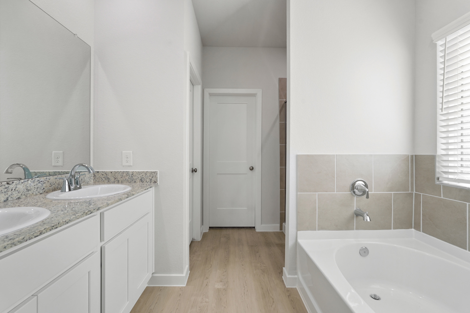 A bathroom with a tub sink and a bathtub.