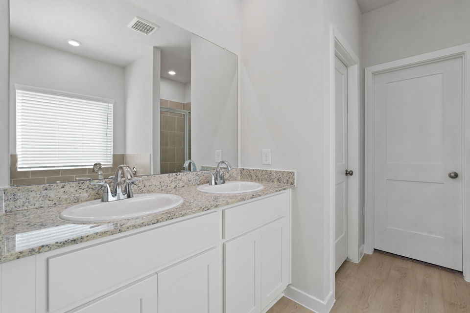 A bathroom with a marble countertop.