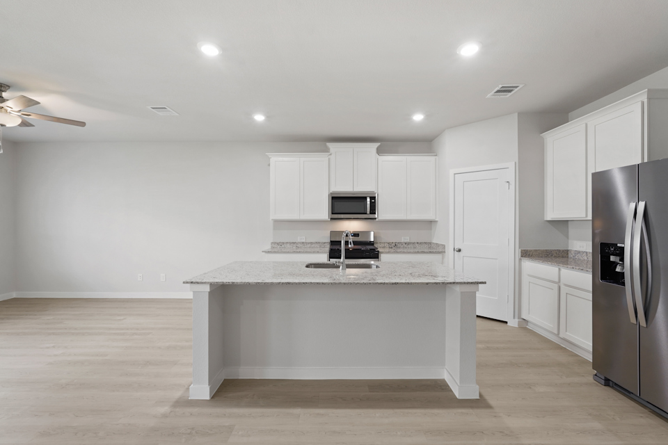 A kitchen with white cabinets.