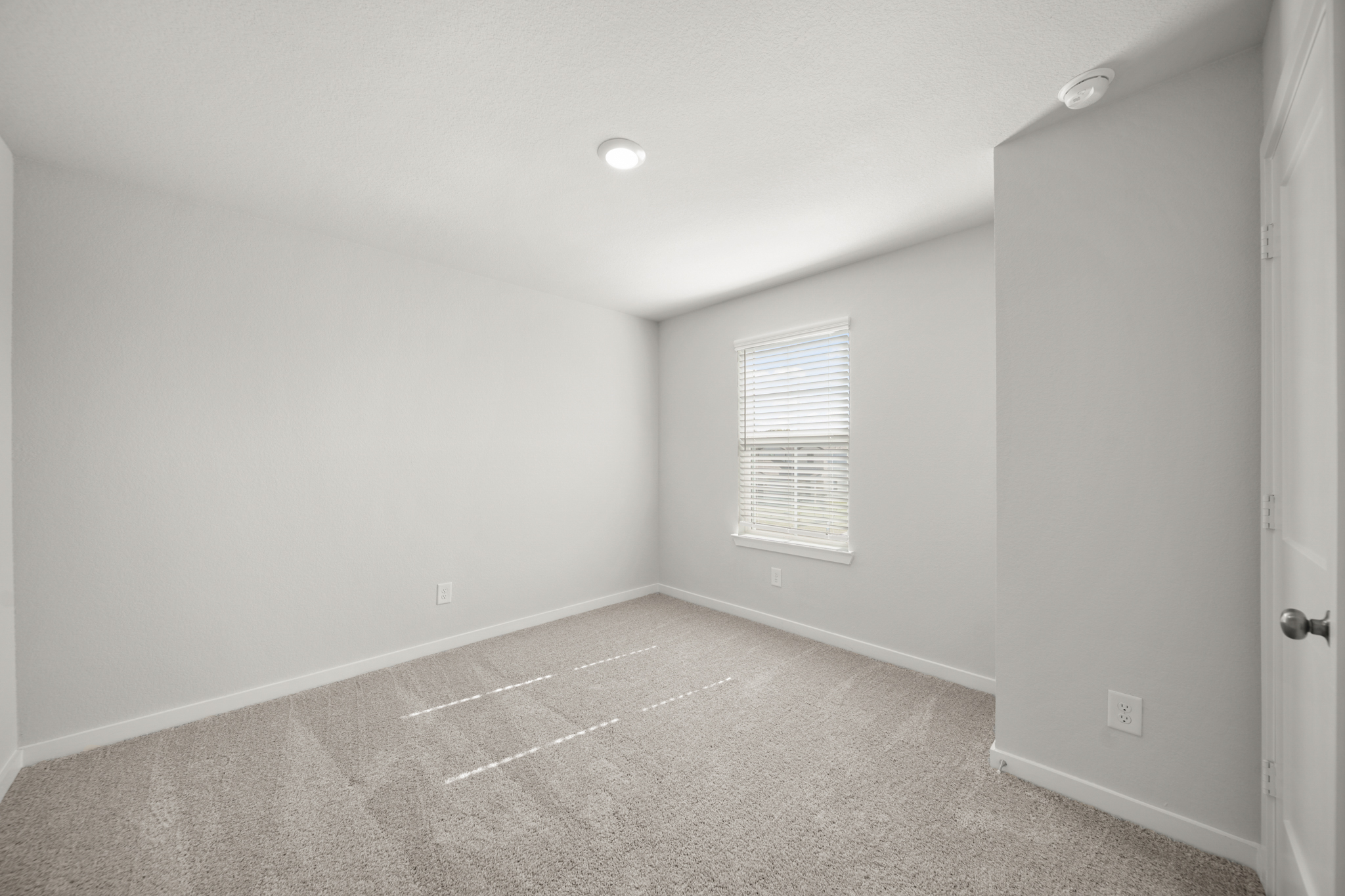 A room with a tile floor and a window.