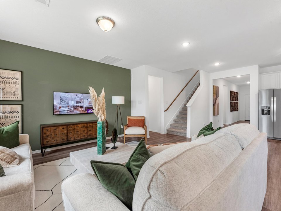 A living room with green walls.