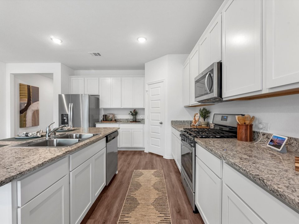 A kitchen with white cabinets.