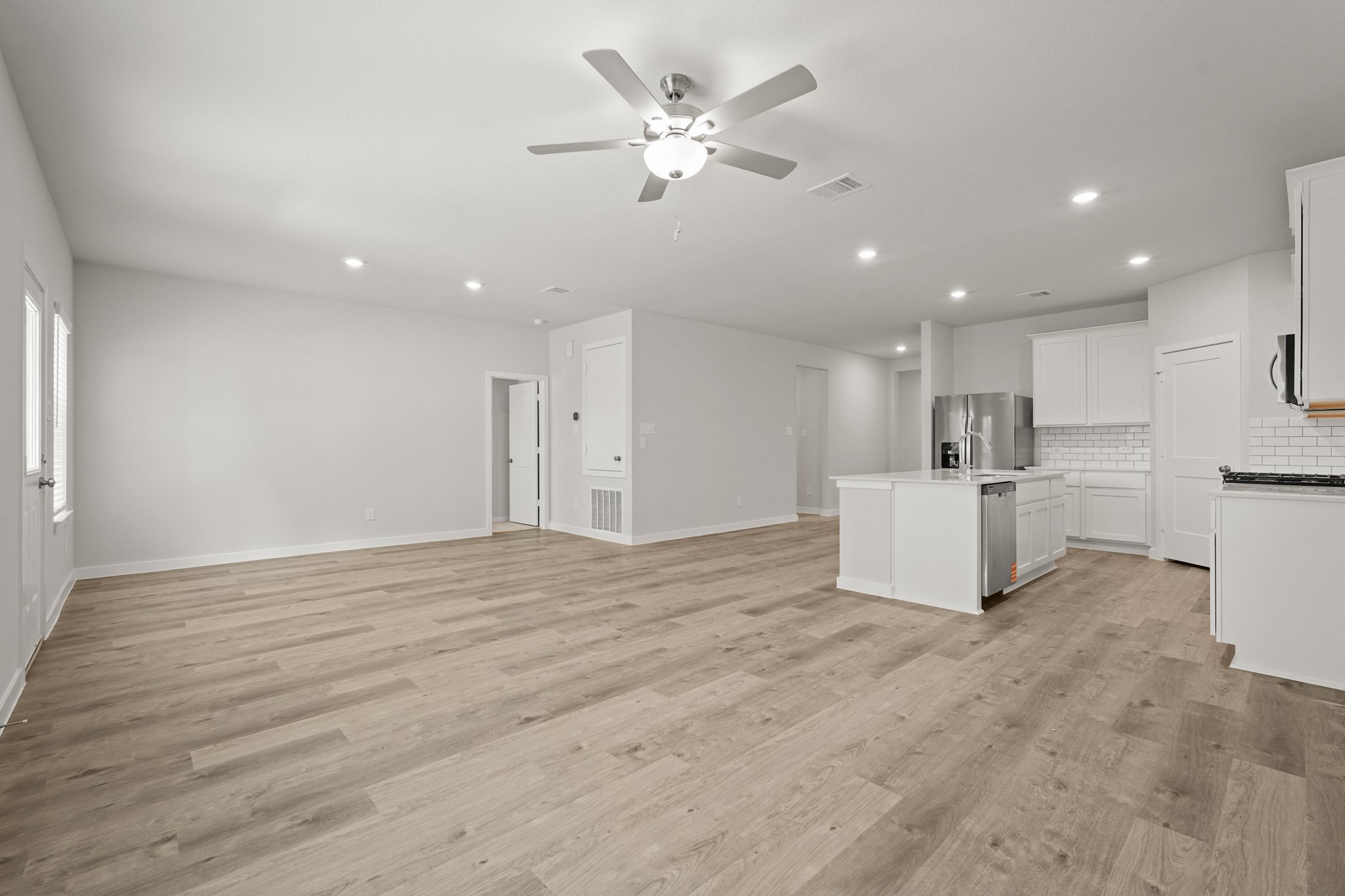 A large kitchen with white cabinets.