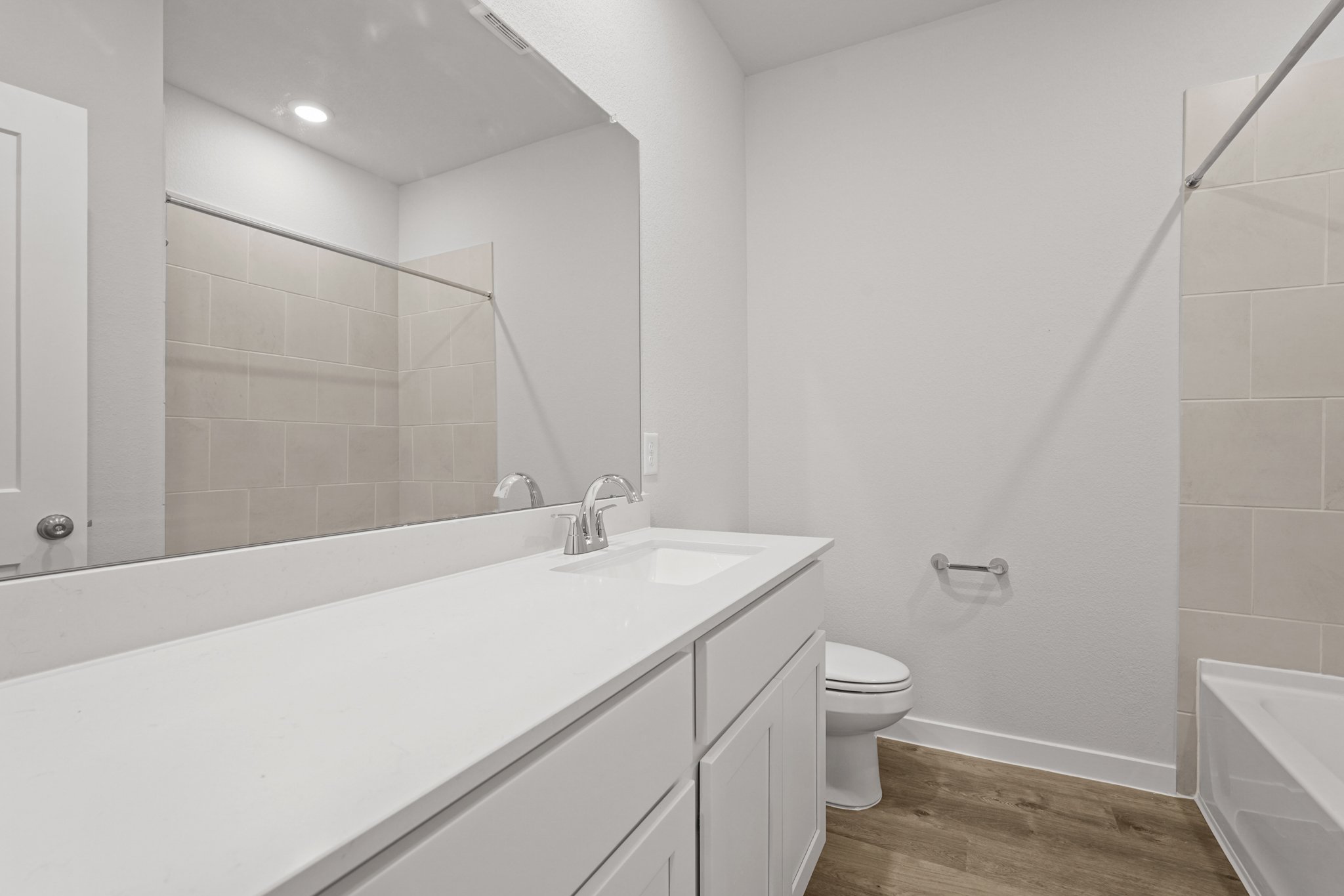 A bathroom with a tub toilet and sink.