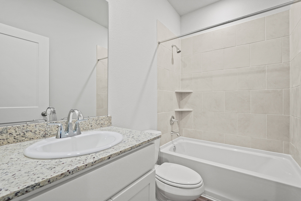 A bathroom with a sink and a tub.